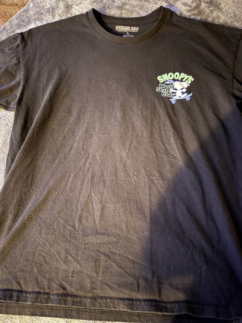 Peanuts Black Tee with Green and Blue Snoopy Skate Graphic